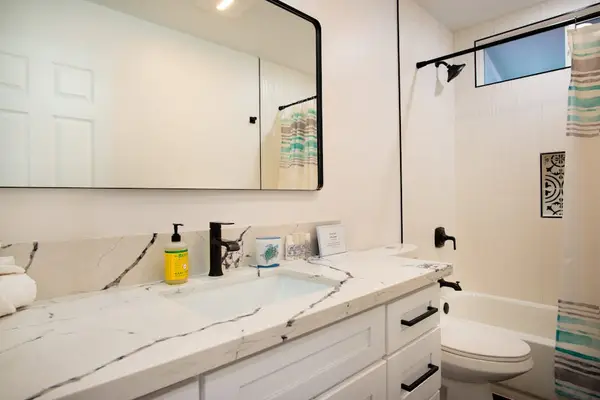 Guest bathroom with tub/shower combo.