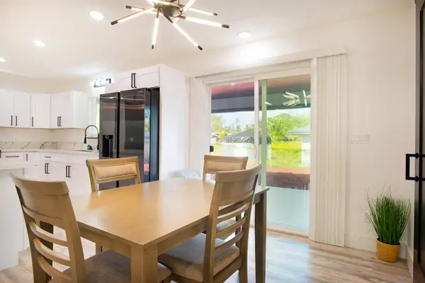 Dining room with seating for four and extra seating at the counter top.