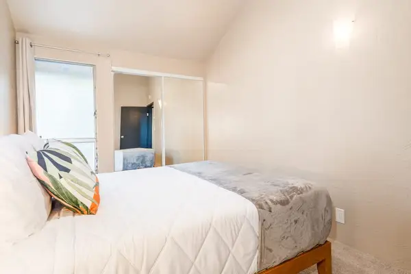 Bright bedroom with views and neutral bedding