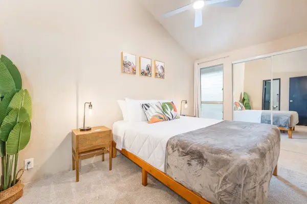 Bedroom with king bed and decorative greenery