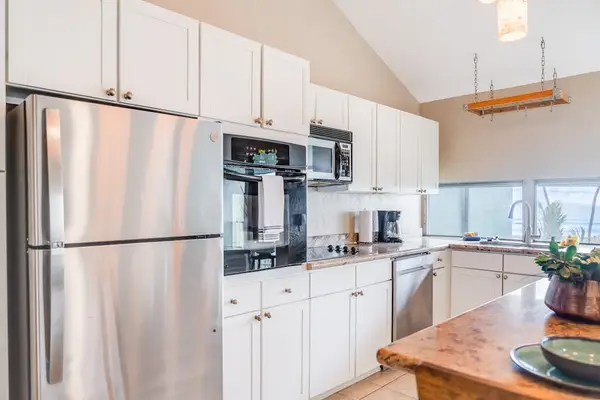 Fully equipped kitchen with white cabinetry