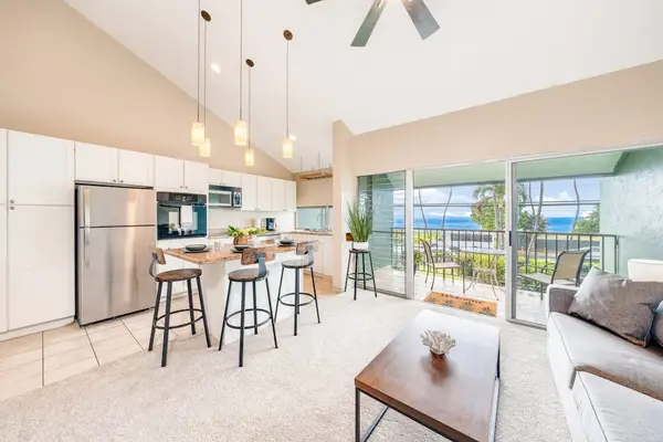 Open kitchen with island and breakfast bar