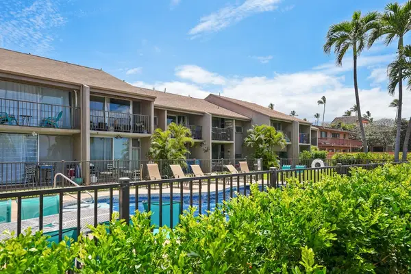 Poolside view framed by palm trees and the building