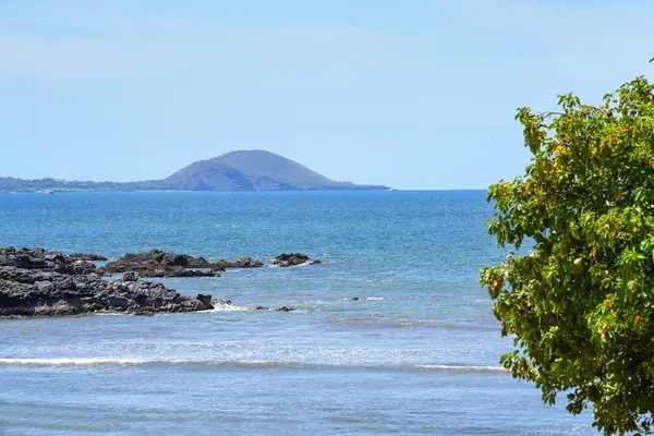 Coastal view with small offshore island in the distance