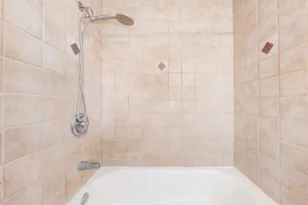 Walk-in shower with neutral tile finishes