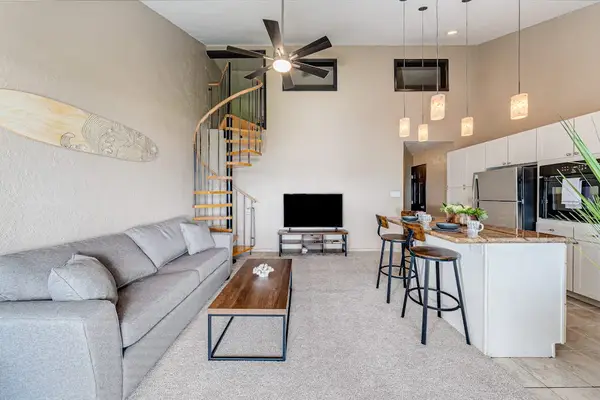Bright open-concept living room with vaulted ceilings
