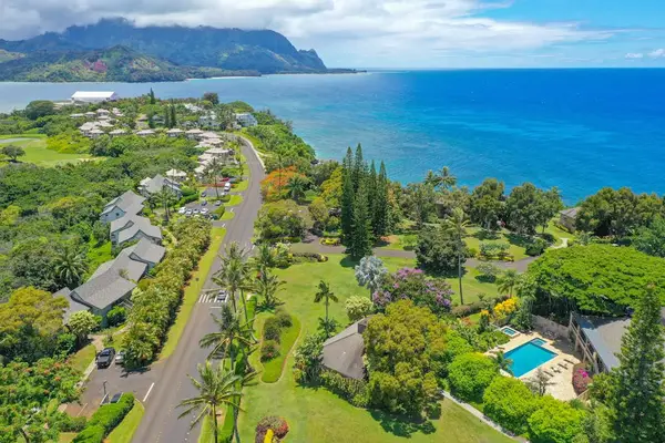 Oceanfront landscape showcases rolling hills, colorful foliage, and scenic shorelines