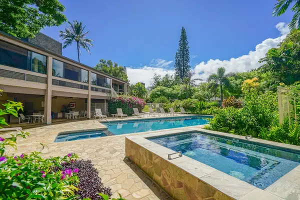 Blue pool waters complement manicured gardens, open skies, and sunshine
