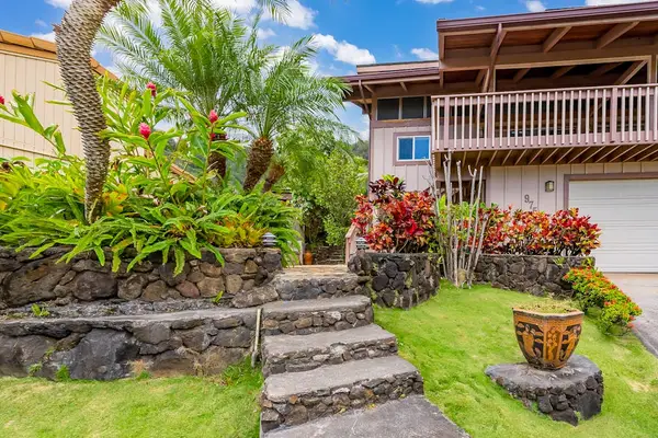 Tropical greenery adds warmth to the inviting exterior entrance
