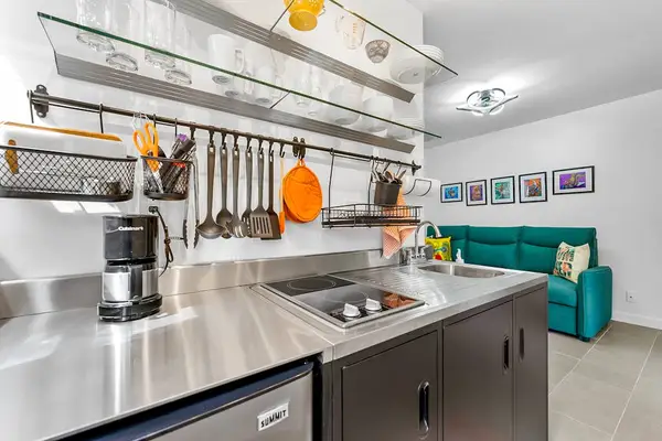 Sleek kitchenette offers convenient space for easy meals