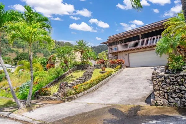 Driveway bordered by tropical landscaping