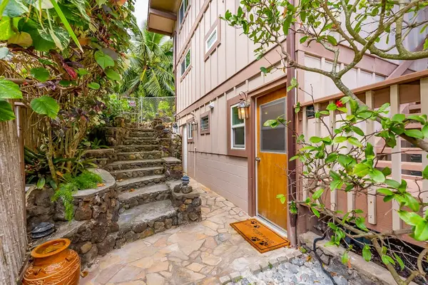 Lush exterior pathway through landscaped greenery