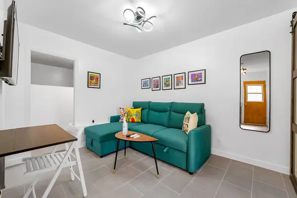Studio room with smart television and sofa bed.