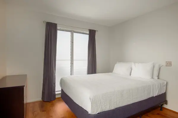 Master bedroom with queen bed and AC in the bedroom.