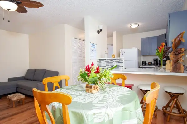 Dining room with seating for four with barstools for extra seating.