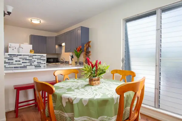 Dining room with seating for four with barstools for extra seating.