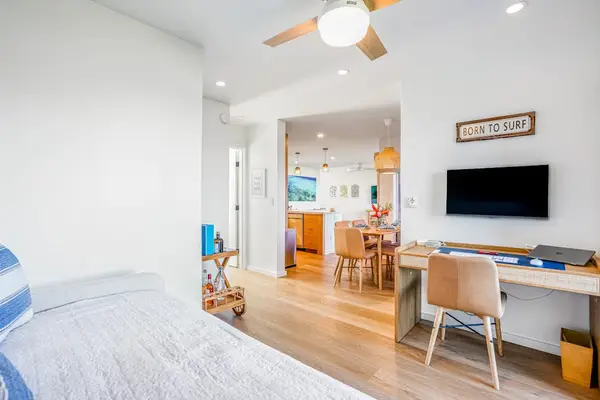 Light-Filled Bedroom Space Showing Open Entry to Dining and Kitchen Areas