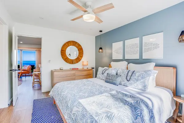 Spacious Primary Suite showcasing Tropical Accents, Large Dresser & Hallway Ocean View