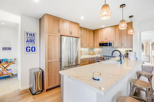 Fully Equipped Kitchen with Stainless Steel Appliances & Breakfast Bar Seating