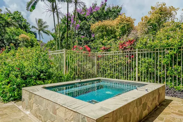 In-Ground Hot Tub Spa nestled among Lush Greenery and Fenced Grounds