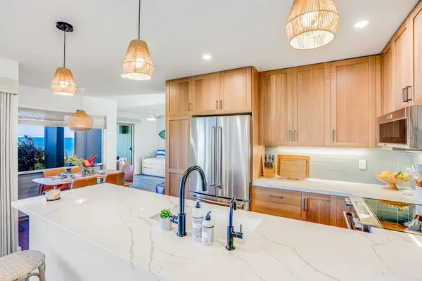 Bright Gourmet Kitchen with Island Counter, Woven Pendant Lights & Modern Sink