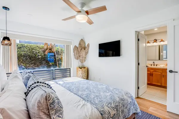 Bright Primary Bedroom with Ceiling Fan, Mounted TV & Direct Access to Ensuite Bath