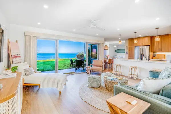 Open-Concept Living Area Featuring Coastal Décor & Sliding Oceanfront Glass Doors