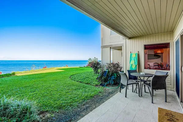 Covered Patio Seating Area Opening to Oceanfront Lawn Views