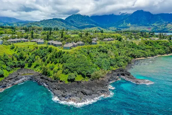 Aerial View of Cliffside Coastal Resort Surrounded by Lush Ocean Views