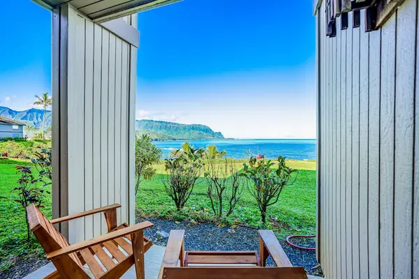 Covered Private Patio Nook with Wooden Armchairs overlooking the Ocean Coastline