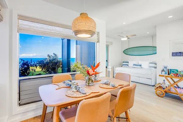 Sunny Dining Area with Wooden Table, Scenic Ocean Window Views & Bar Cart