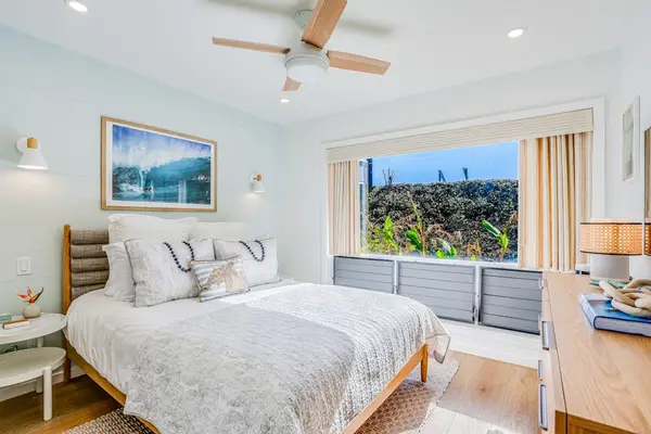 Tranquil Master Bedroom with Plush Queen Bed, Ceiling Fan & Large Picture Window