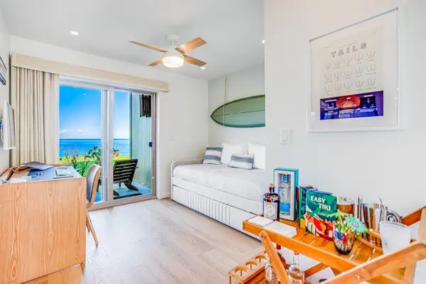 Versatile Guest Bedroom featuring Daybed with Trundle, Work Desk & Ocean View Sliding Door