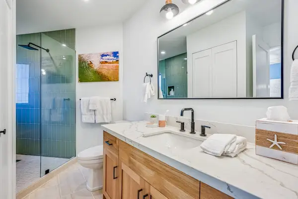 Modern Bathroom with Spacious Vanity, Large Mirror & Walk-In Glass Shower