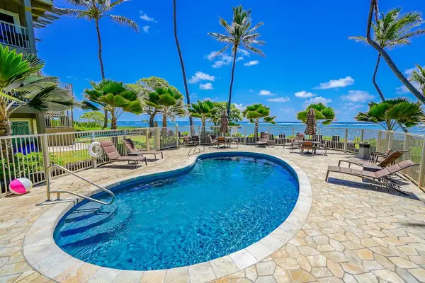 Relax poolside surrounded by tropical landscaping