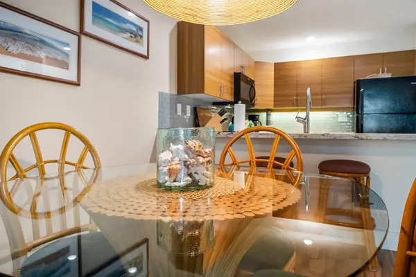 Rattan dining chairs gather around bright meals beside kitchen views