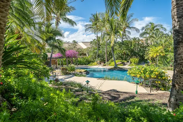 Crystal clear water invites leisurely laps beneath brilliant Hawaiian sunshine
