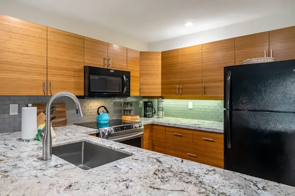 Kitchen counters offer efficient preparation space beneath practical cabinetry and appliances