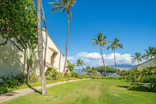 Tropical foliage frames grounds with palms gardens and open spaces