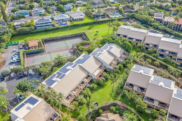 Aerial view showcases tropical surroundings with lush gardens and ocean vistas