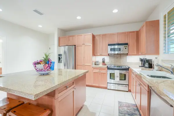 Newly remodeled kitchen with stainless steel appliances and a large island for extra counter space.   Two barstools for extra seating.