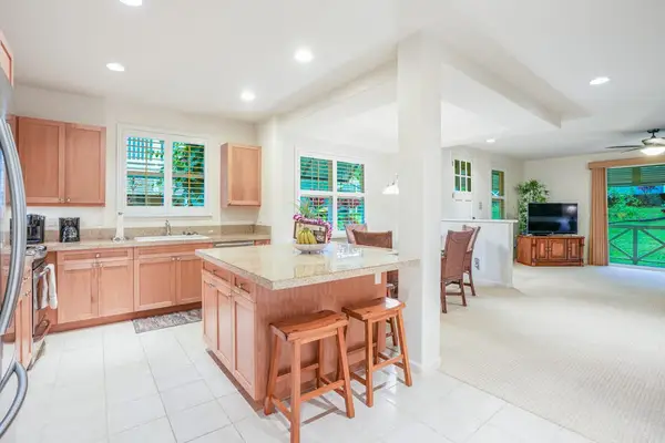 Newly remodeled kitchen with stainless steel appliances and a large island for extra counter space.   Two barstools for extra seating.