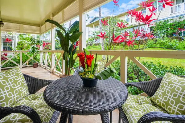 Private lanai surrounded by lush tropical paradise, vibrant flowers, and swaying palms—the perfect place to relax and soak in the island atmosphere.