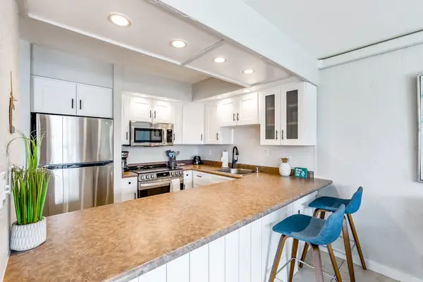 The modern kitchen is fully equipped for easy meal preparation.