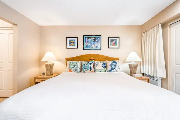 Features king bed bedside lamps and ceiling fan