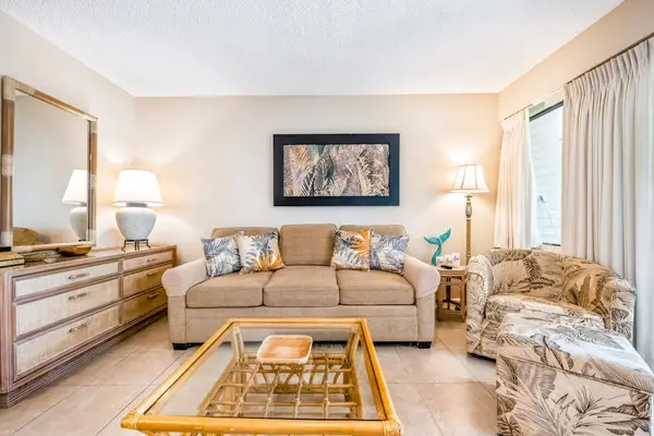 Comfortable living room offers sofa seating coffee table and artwork