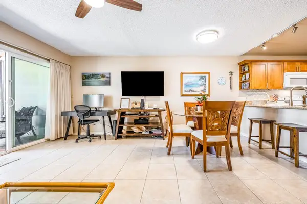 Open living area connects dining kitchen patio through sliding doors