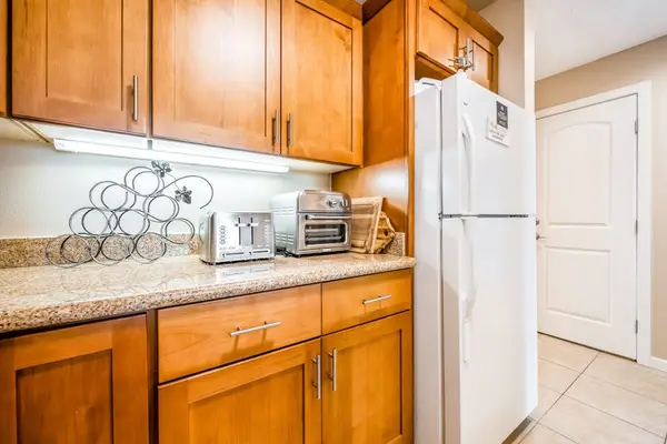 Kitchen cabinetry surrounds practical appliances and generous counter workspace area