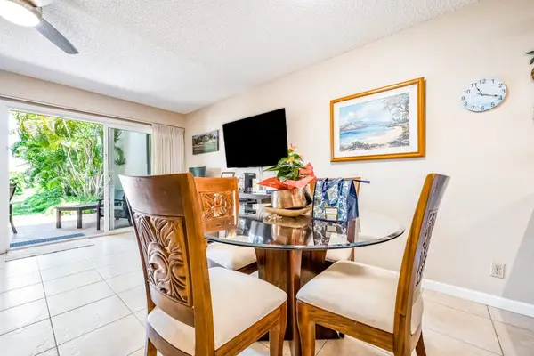 Dining table creates welcoming setting beside nearby garden-facing glass doors