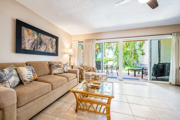 Open living room offers comfortable seating with bright garden access